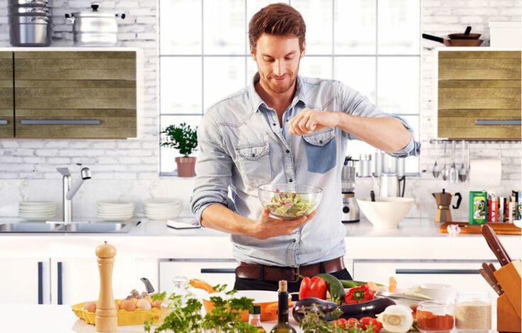 vyras ruošia daržovių salotas, kad padidintų potenciją